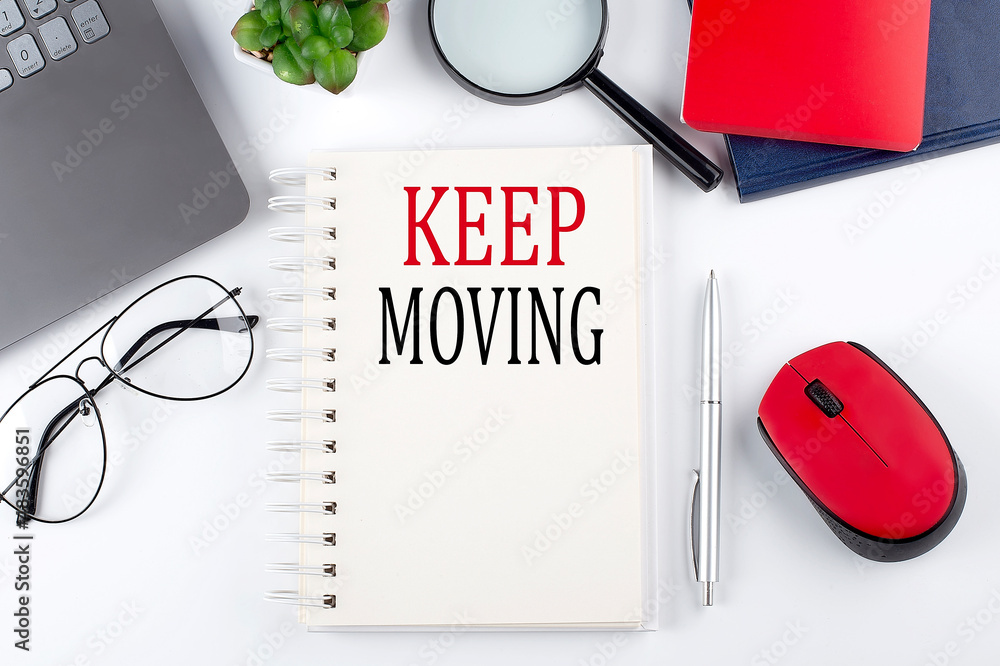 Poster keep moving text on a notepad with laptop on the white background