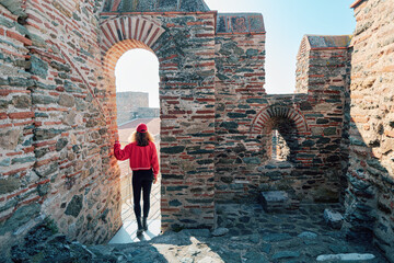 Traveler girl on the viewpoint of a byzantine castle Heptapyrgion in Thessaloniki. The concept of...