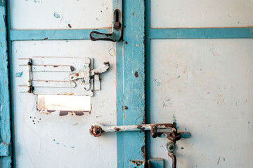 The scary and rusty door to the detention cell in the prison. The concept of conviction and the penitentiary system.
