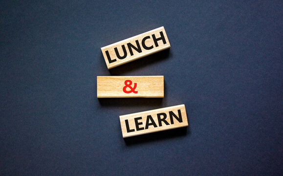 Lunch and learn symbol. Concept words Lunch and learn on wooden blocks. Beautiful black table black background. Copy space. Business, educational and lunch and learn concept.