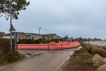 Pink water tube om the shore in Frederikssund to prevent the storm flood Malik