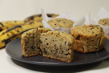 Plantain muffins. A healthy snack with extra ripe plantains, whole wheat flour and sesame seeds as the ingredients. Shot with muffins inside parchment paper cups