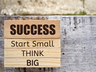 Inspirational and Motivational Quote - 'success start small think big' text background. Stock photo.