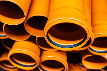 Sewer pipes made of polypropylene are stored in the warehouse of a specialized store. Sale of...