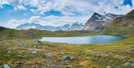 Idyllic blue alpine lake high up on the mountains, scenic landscape rocky terrain at high altitude...