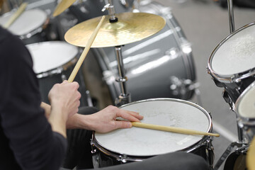 A close up of musician's hands. Drum kit playing.