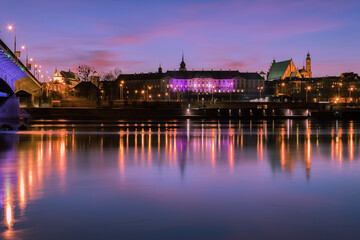 Warsaw cityscape with Old Town buildings across Vistula River at sunset. - 483603462