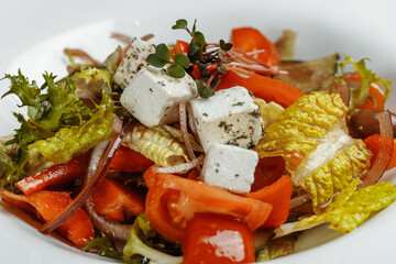 Greek salad with fresh vegetables, feta cheese and black olives