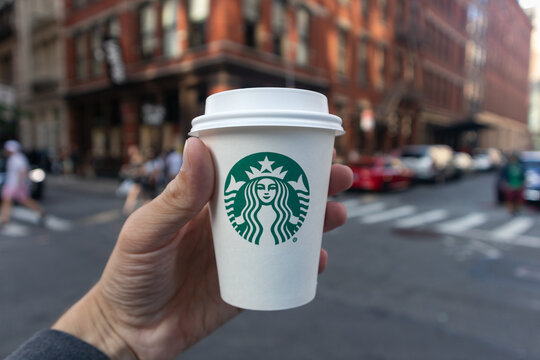 Cup of Starbucks Coffee Held by a Hand in SoHo of New York City on September 25, 2021 in New York, New York