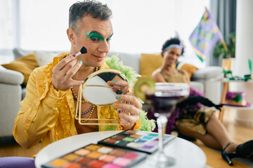 Smiling puts on colorful Mardi Gras make-up while getting ready for the carnival.