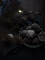 Plum on a dark table.