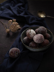 Plum on a dark table.