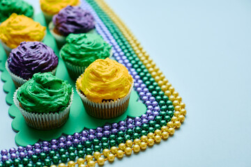 Cupcakes in traditional Mardi Gras colors during celebration festival.