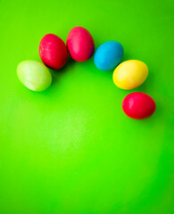 Pattern of colorful Easter eggs on a green background.