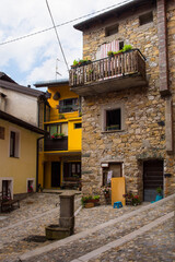 Historic buildings in the village of Dordolla in the Moggio Udinese of Udine province, Friuli-Venezia Giulia, north east Italy. A small corn field is in the foreground