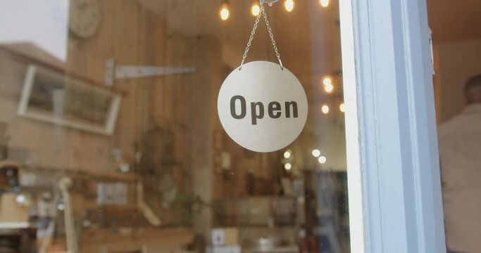 Male Small Business Owner Opening Store Turning Open Sign