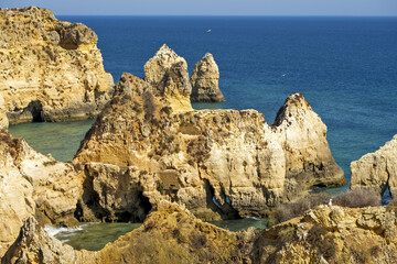 Praia da Praínha beach between the yellow cliffs with sand areas in Portimao, algarve, portugal 