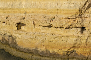 yellow cliff, sand and clear water at the Carvalho beach, Algarve, Portugal
