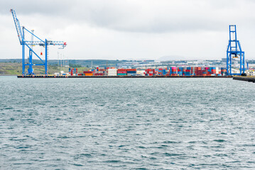 Colourful containers on a pier in a deserted harbour on a cloudy day. Reykjavik, Iceland.