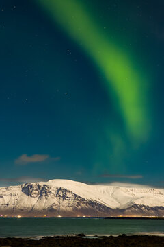 Northern Lights over the snowcapped Mount Esja in the Icelandic capital, Reykjav&iacute;k