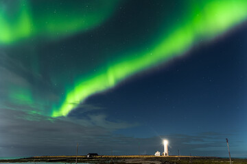 Spectacular show of the Northern Lights over Grotta Island lighthouse in Reykjavík - the capital...