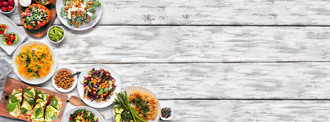 Healthy plant based low carb meal corner border. Top view over a white wood banner background....