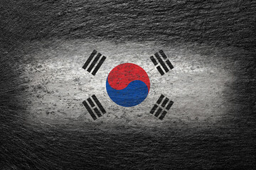 Flag of South Korea. Korean flag is painted on a black stone. Creative background. 