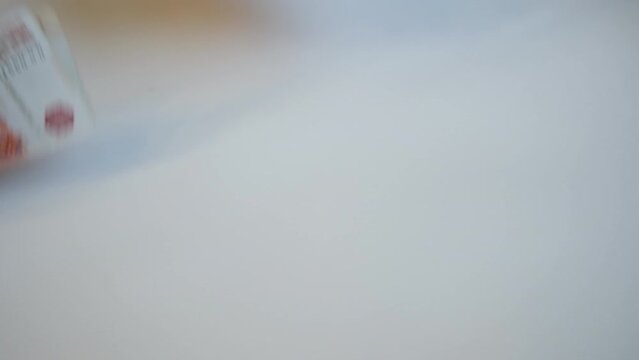 Women's hands pick up several five-thousandth banknotes lying on a white background and put them in a wallet. We paid for the work with Russian 5000 banknotes