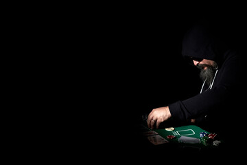 poker player in the darkness with copy space