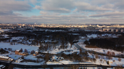 Low-rise urban development. The ground and buildings are covered with snow. Winter cityscape. Aerial photography.