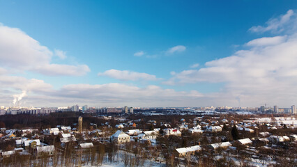 Obraz premium Low-rise urban development. The ground and buildings are covered with snow. Winter cityscape. Aerial photography.