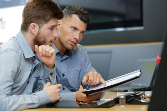two male engineers working with new project