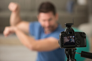 Fototapeta na wymiar man filming himself exercising for a blog