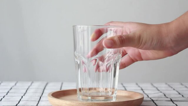 Take an empty glass from the table.
