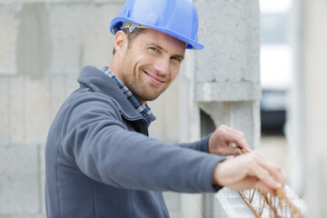 portrait of a smiling builder working outdoors