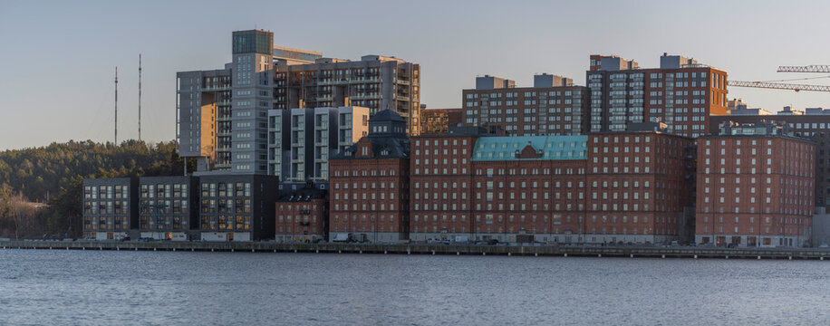 Panorama view over apartment houses in the island Kvarnholmen, tower house replaced silon for seed, a sunny winter day at the waterfront in the district Nacka in Stockholm