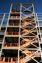 construction of a new inner city  multi storey car-park showing the unfinished steel girder stairwell shot from below converging verticals