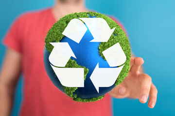 hand holding green recycle symbol