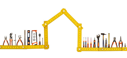 DIY and home maintenance. Work tool set and house shape wooden measure isolated on white