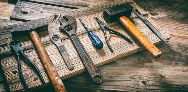 Work tool old used on wood table. Construction industry, carpentry vintage equipment, overhead