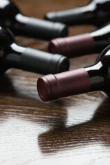 Various Wine Bottles on a Reflective Wood Surface Abstract.