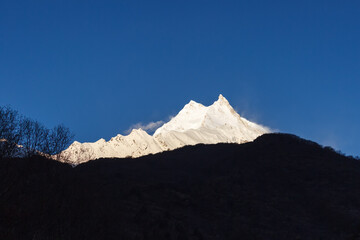 Snow-capped mountain peaks illuminated by dawn in manaslu Himalayas