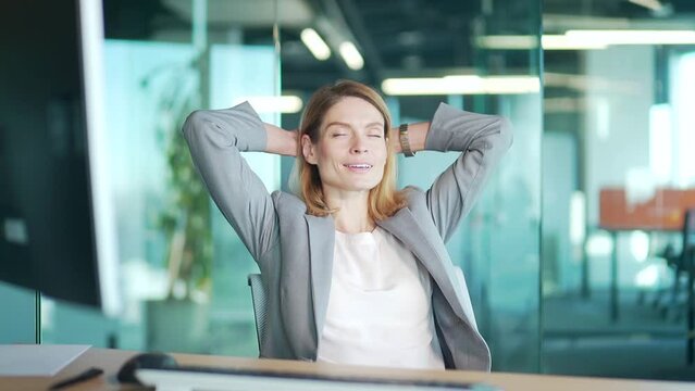 Business woman office worker relaxes at workplace. Portrait female employee or entrepreneur dreams of a vacation with her eyes closed in the office at a computer desk. silence calm and rest