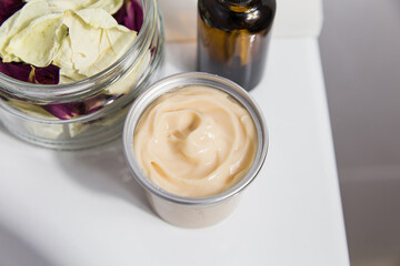 Natural cosmetics for face, body and hair care in jars on the edge of the bath, close-up