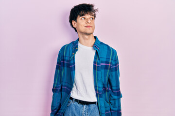 Fototapeta premium Handsome hipster young man wearing casual white t shirt and vintage shirt smiling looking to the side and staring away thinking.