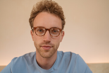 Close up portrait of pensive  handsome man having video call 