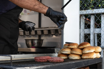 Hamburger meat on the grill about to be prepared
