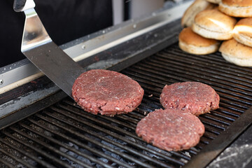 Hamburger meat on the grill about to be prepared