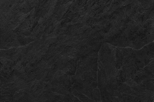 Dark grey black slate background or texture. Black granite slabs background.	