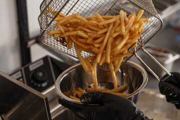 Fries pouring out of the fryer basket